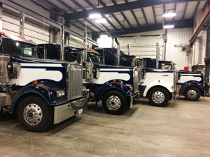 Bulk water hauling trucks about to be serviced in Liquids in Motions Ltd. Millet shop. 