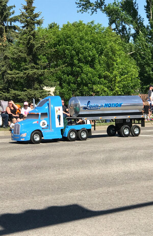 Small version of a liquids in motions water hauling truck taking part in Leduc Black Gold Pro Rodeo's parade