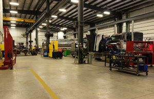 State of the art 20 bay shop with two trucks being serviced