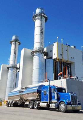 Blue Liquids in Motion Ltd. truck in front of a chemical plant.